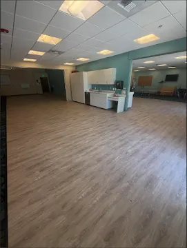 Luxury vinyl plank flooring installed across a large open commercial room