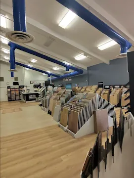 EZ Floors & More showroom with flooring sample racks and displays