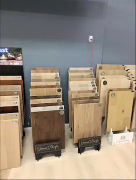 Hardwood flooring sample boards displayed on stands in a showroom